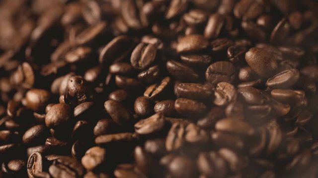 closeup of roasted coffee beans with smoke