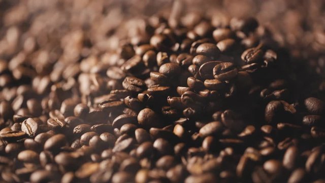 roasted coffee beans with smoke falling down