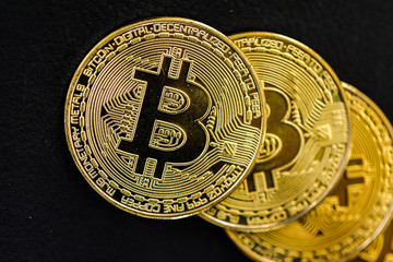 Physical Bitcoins (crypto currency) on a black background