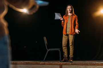 young actor with screenplay on casting with theater director