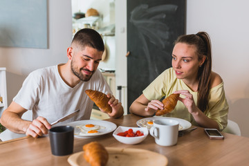 romantic couple having breakfast at home