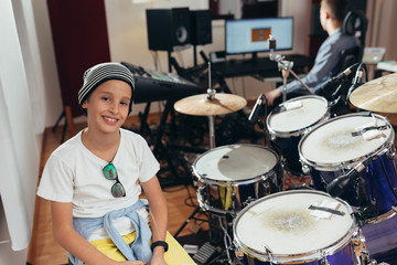 young boy playing drums at the music studio
