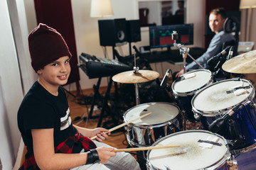young boy playing drums at the music studio