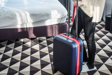 hotel visitor with a suitcase in the hotel room. Concept on the theme of arrival in the hotel room