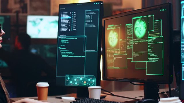 Girl hacker sitting at her super computer