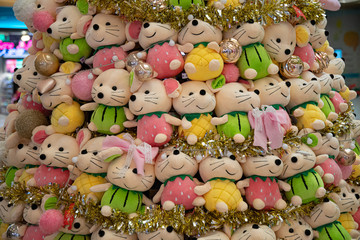 Fototapeta na wymiar Variety of soft toy animals closeup. Background of stuffed toy colorful mice decorated with golden tinsel. Backdrop of cute plush toys. Symbol of Chinese New Year.