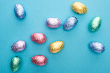 Top view of chocolate Easter eggs on blue background