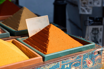 Colorful triangle piles of spices on an oriental spice market