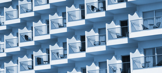 Portrait of hotel or apartment building with balconies.