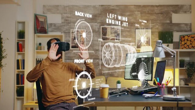 Male engineer in home office using VR headset to study the functionality of turbine prototype