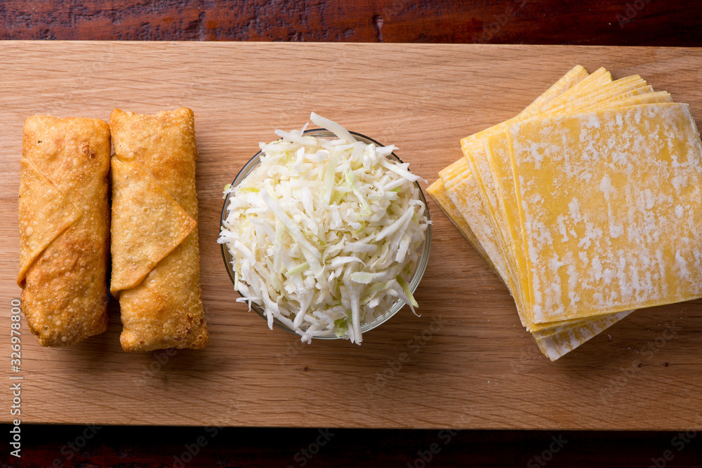 Wall mural Eggrolls or Springrolls. Traditional Chinese, Thai or Japanese restaurant appetizer, fried. Made from wonton wrappers & filled with Chinese veggies and served w/ a chili dipping sauce or soy sauce.  