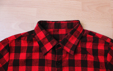 Plaid shirt checkered pattern close up top view. Flannel shirt tartan fabric texture, stylish urban...