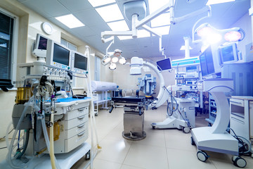 Clinic interior with operating surgery table, lamps and ultra modern devices, technology, hi-tech interior, medicine concept