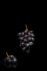 bunch of grapes on black background