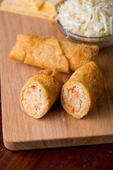 Egg rolls or spring rolls fried.Traditional Chinese Thai restaurant appetizer, spring rolls or egg rolls. Made from wonton wrappers and filled with Chinese veggies and served w/ chili dipping sauce.