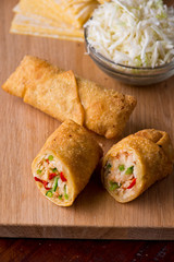 Egg rolls or spring rolls fried.Traditional Chinese Thai restaurant appetizer, spring rolls or egg rolls. Made from wonton wrappers and filled with Chinese veggies and served w/ chili dipping sauce.
