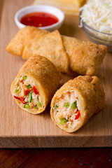 Eggrolls or Springrolls. Traditional Chinese, Thai or Japanese restaurant appetizer, fried. Made from wonton wrappers & filled with Chinese veggies and served w/ a chili dipping sauce or soy sauce.  