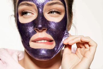 Charming pretty girl removing cosmetics