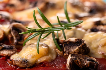 rosemary on a mushroom pizza on a plate