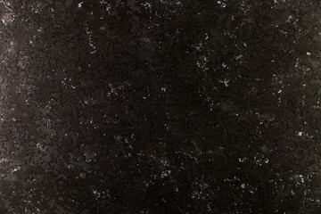 Dark concrete wall with coarse surface