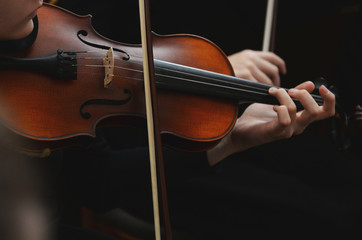 Close up of violin with bow in hands