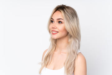 Naklejka premium Teenager blonde girl over isolated white background . Portrait