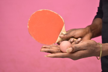 handsome young black man holding a table tennis ball in hand ready to serve