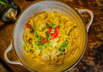 Closeup of pasta with cheese, minced meat and herbs. View from above