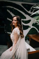 Fototapeta premium Young Bride in gorgeous dress in beautiful interior