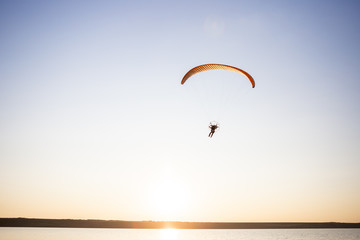 Paraglider fly, sunset time.