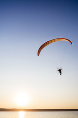 Paraglider fly, sunset time.