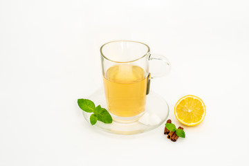 glass cup of lemon tea whith lemon, mint and cardamon isolated on the white background