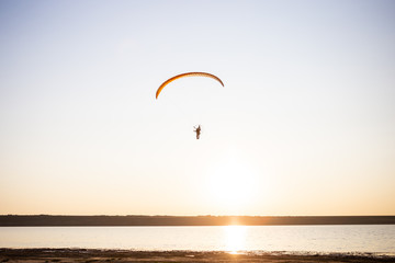 Paraglider fly, sunset time.