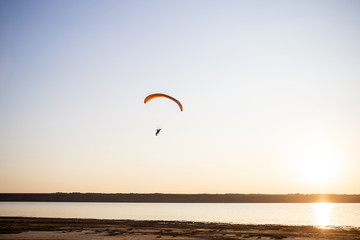 Paraglider fly, sunset time.