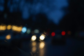 Blurry Headlight Backgrounds. Headlights of an oncoming car, blurred by rain.