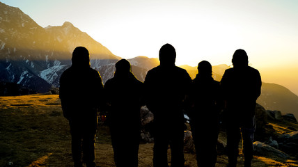Fototapeta na wymiar silhouettes of people on top of the mountain
