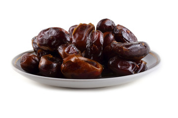 Date fruits on saucer isolated on white