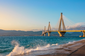 Rion Antirion Bridge and Spray of Surf at Sunset Light