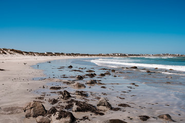 Natural long beach in Africa with waves and stones