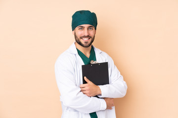 Surgeon in uniform isolated on beige background