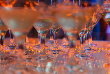 Champagne glasses standing in a tower at the party