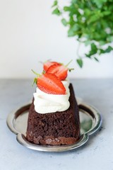 Chocolate brownie with airy vanilla cream and fresh strawberries. Chocolate cake with cream and fresh berries. Tea dessert
