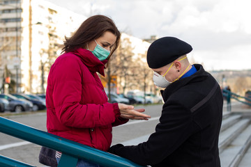  Young couple wearing masks to protect them from viruses, smog, and other atmospheric pollutants in...
