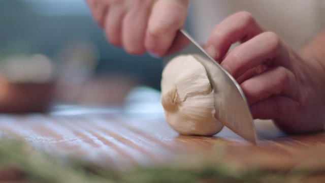 chef is cutting garlic with knife
