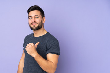 Caucasian handsome man proud and self-satisfied over isolated purple background