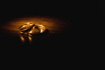 Beautiful wedding gold rings on dark background