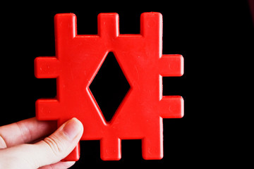 Obraz premium Children's cubes. Children's toy in the hands of a woman close-up. Geometric shapes close up.