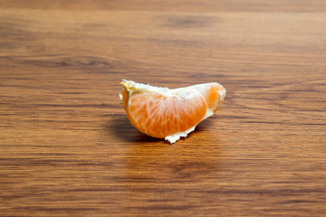 Sweet, juicy, ripe tangerine on a wooden table.