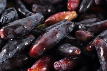 Honeyberries background. Far Eastern delicacy. Macro