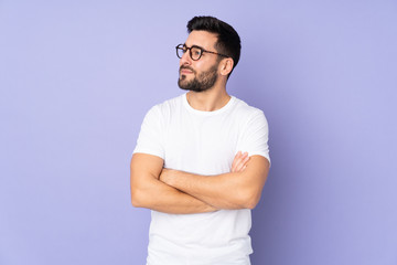 Caucasian handsome man over isolated background looking to the side